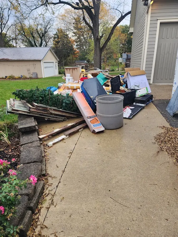 Dumpster being loaded with debris for Roofing Dumpster Rental in Strongsville